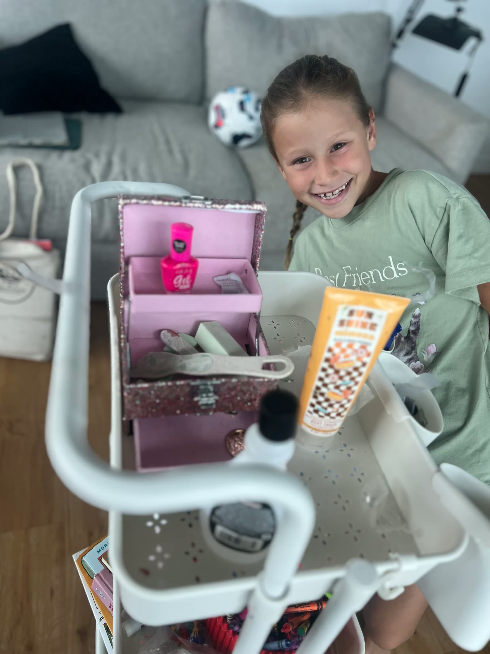 A girl smiling beside the cart of supplies she set up for her at-home spa